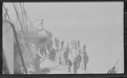 Image of Many sealers by vessel. Boat in davit